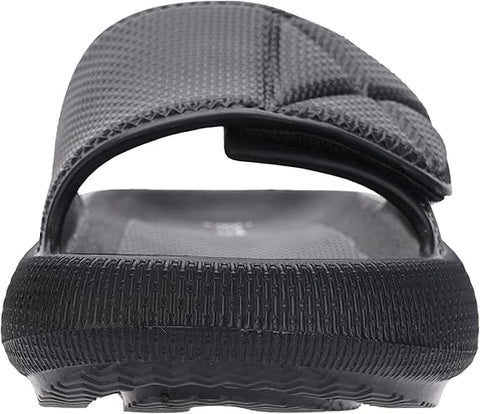 Black sandal with a textured sole on a white background