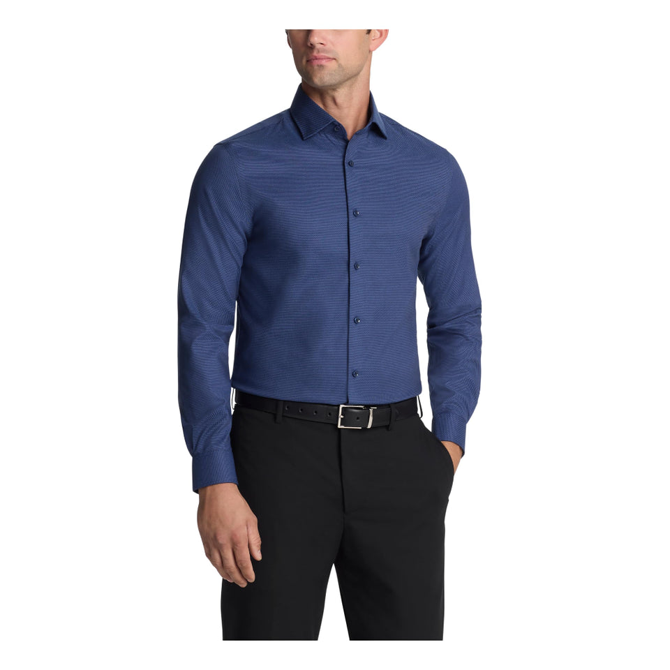 A man wearing a blue long-sleeve button-down dress shirt with a subtle textured pattern, paired with black trousers and a black belt, shown against a plain white background.