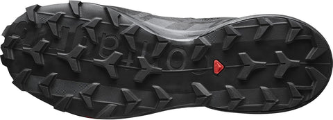 Close-up of a black shoe sole with a brand logo on a white background