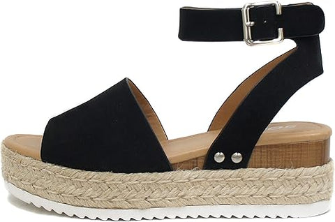 Black sandal with wooden sole and jute wedge on a white background