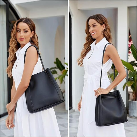 Woman in a white dress holding a black handbag in an indoor setting with plants.