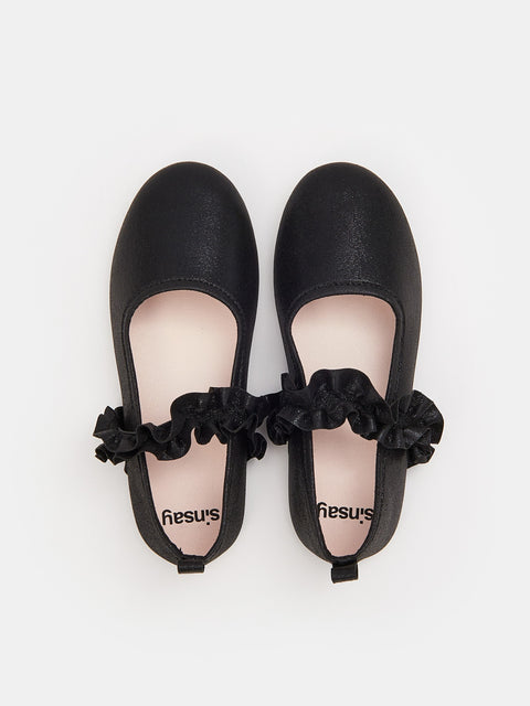 Black ballet flats with ruffles on a white background