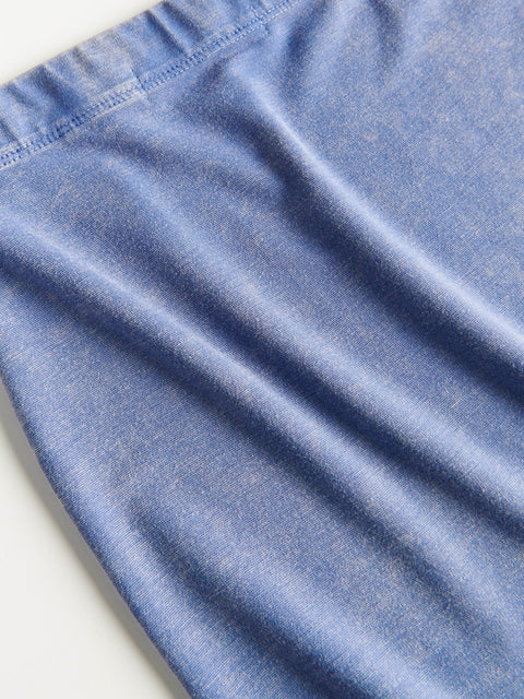 Close-up of blue denim fabric with a light background