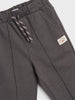 Gray sweatpants with a brand logo on a light gray background
