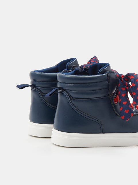 Navy high-top sneakers with a decorative bow on a white background