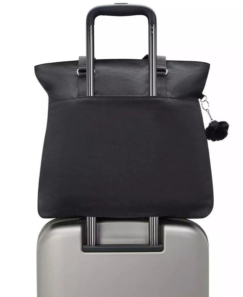 Black travel bag with a handle on top of a silver suitcase