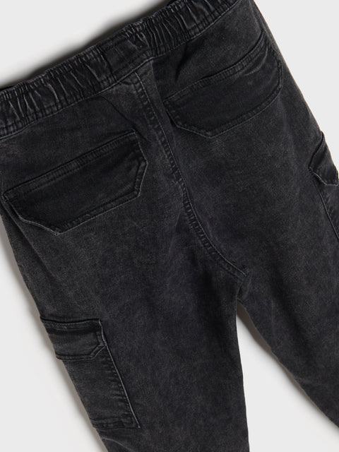 Black jeans with cargo pockets on a white background