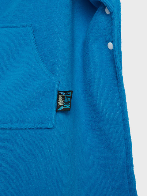 Blue shirt with a small black label on a white background
