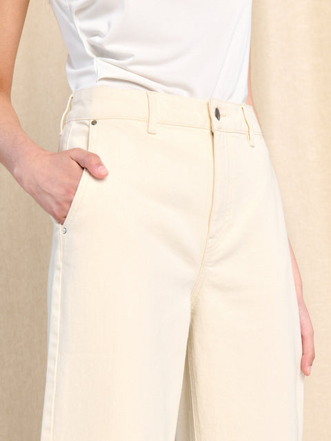 Person wearing light-colored pants with a neutral background