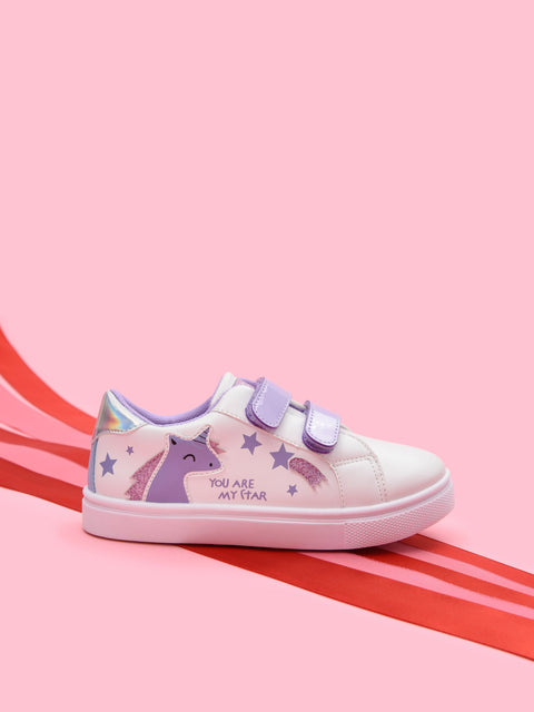 Children's sneaker with unicorn design on a pink background