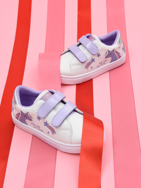 White sneakers with purple straps on a striped red and pink background