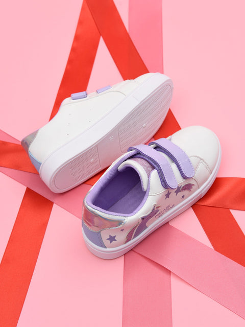 Pair of white sneakers with purple accents on a pink and red background