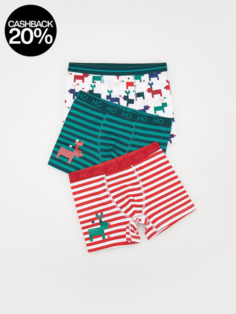 Three pairs of boys' underwear with festive designs on a white background