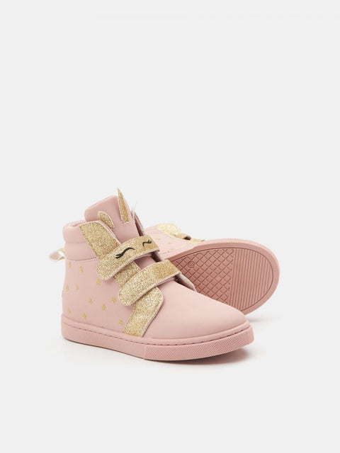 Pink high-top sneakers with gold accents on a light pink background