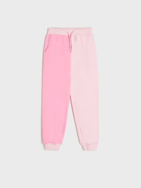 Pink sweatpants on a light gray background