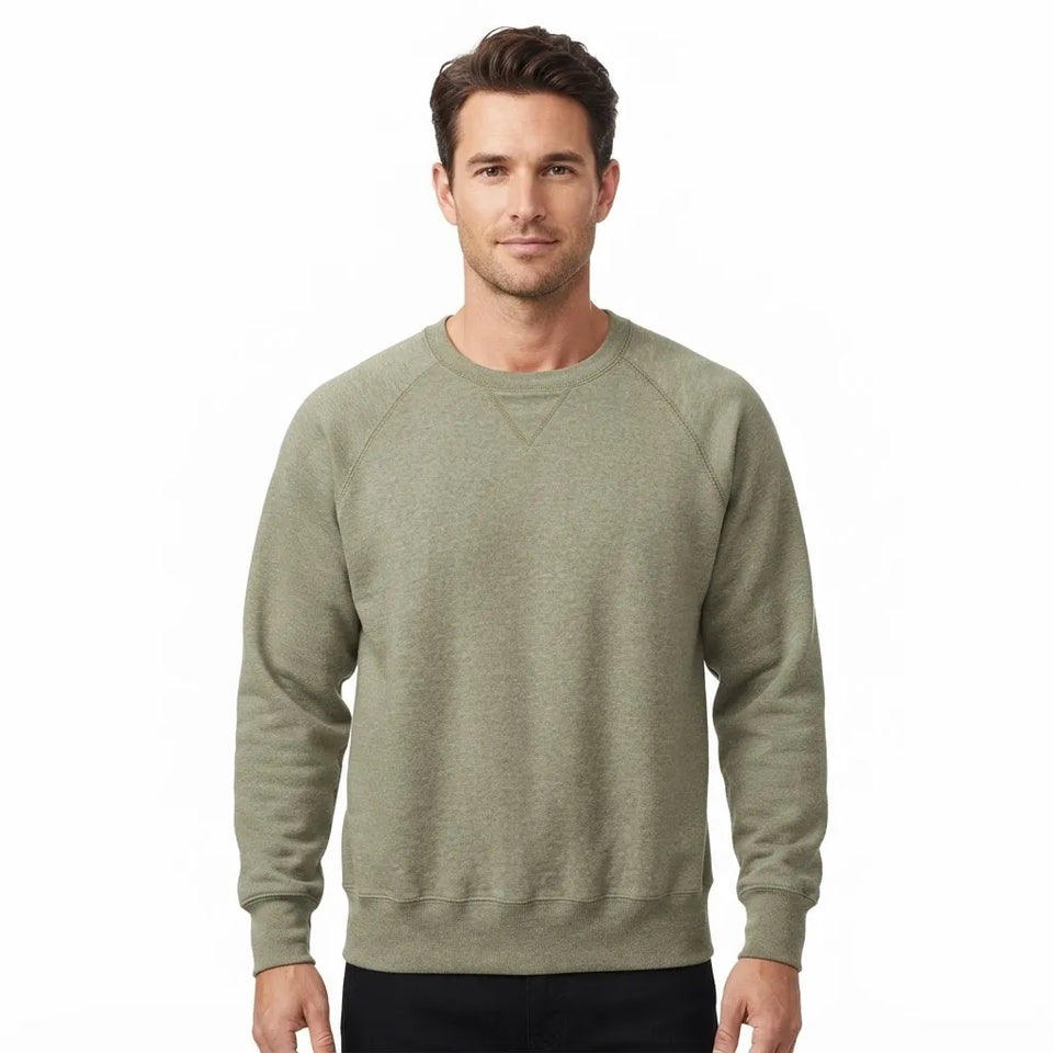 A man wearing a heathered sage green crewneck sweatshirt, shown from the waist up against a plain white background.