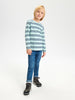 Child wearing a striped shirt and jeans on a white background