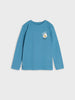 Blue long-sleeve shirt with a small graphic on a light gray background