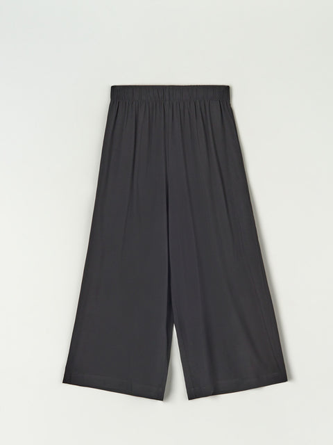 Black wide-leg pants on a light gray background