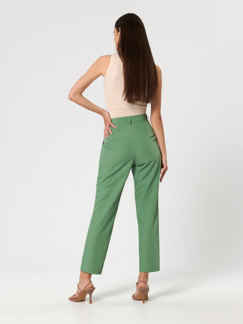Woman wearing green pants on a white background
