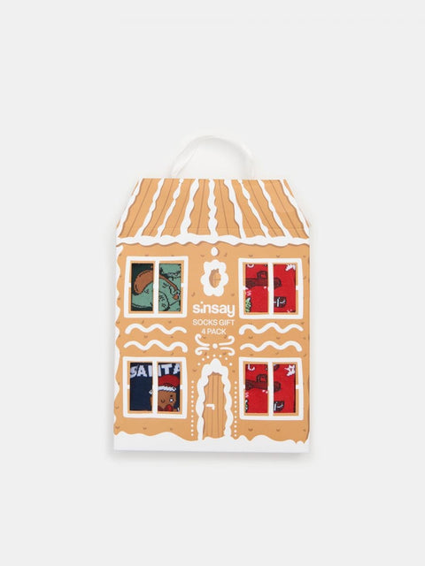Gingerbread house-shaped packaging with Sainsbury's branding on a white background
