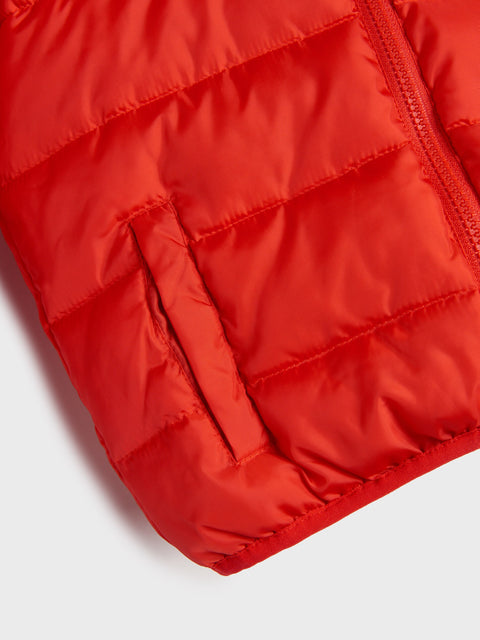 Close-up of a red puffer jacket on a white background