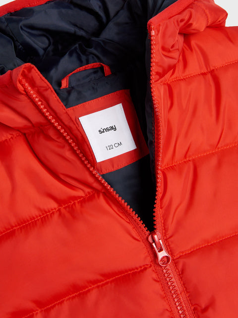 Red puffer vest with a visible brand label on a white background