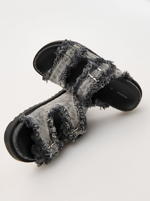 Pair of gray frayed sandals on a white background