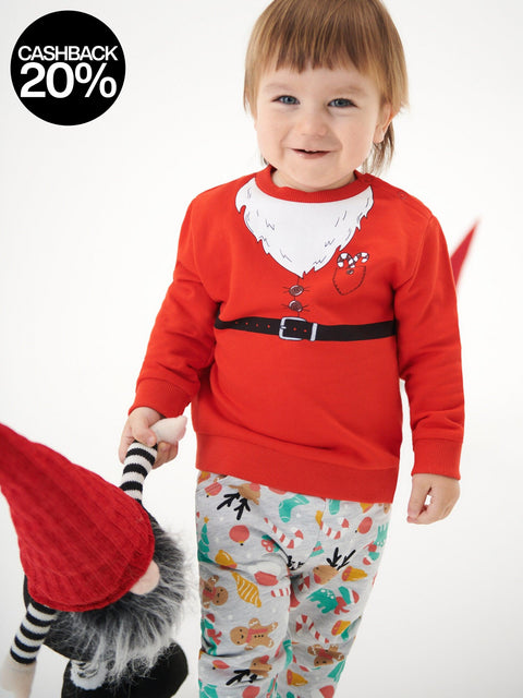 Child wearing a red sweater with a cartoon design on a white background