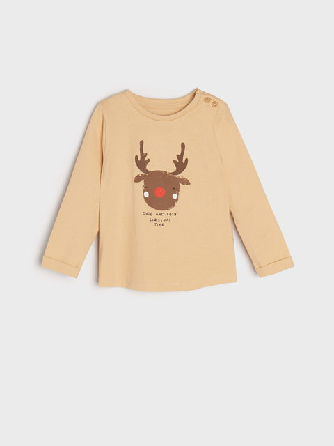 Beige long-sleeve shirt with a reindeer graphic on a light gray background