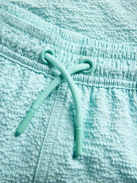 Close-up of a turquoise textured fabric with a drawstring