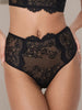 Black lace high-waisted briefs worn by a model, featuring intricate floral lace patterns over sheer mesh, with a scalloped waistband.