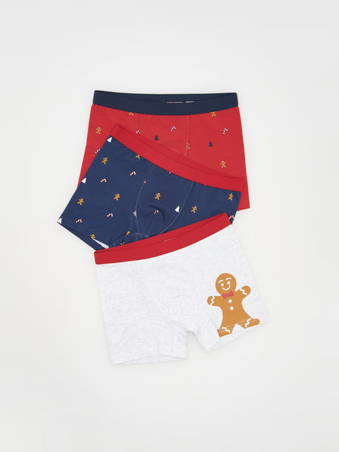 Set of three pairs of underwear with different patterns on a white background