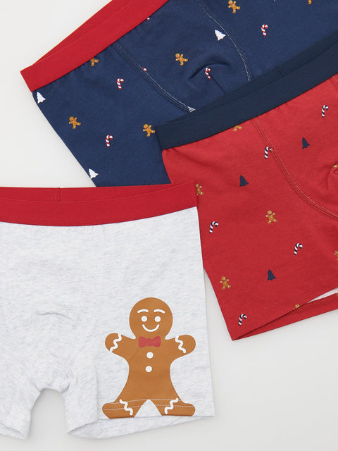 Set of three pairs of underwear with gingerbread man design on a white background