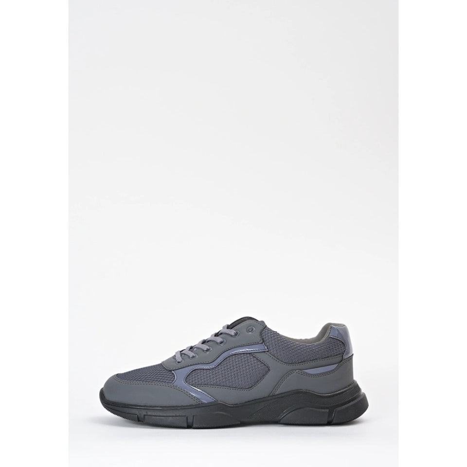 A gray low-top sneaker with a chunky black sole, shown in a side profile against a clean white background.