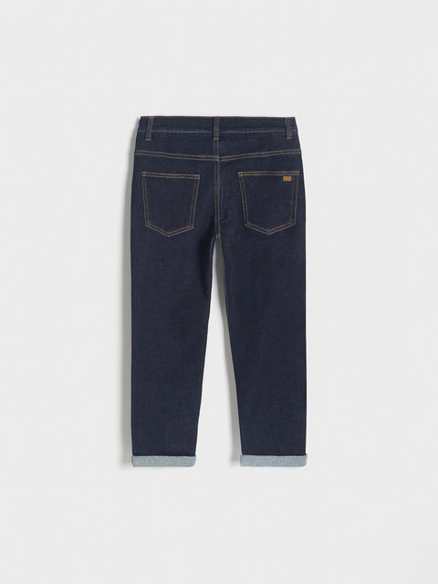 Dark blue jeans on a light gray background