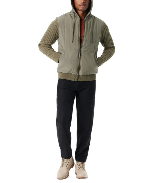 Person wearing a green jacket with a hood on a white background