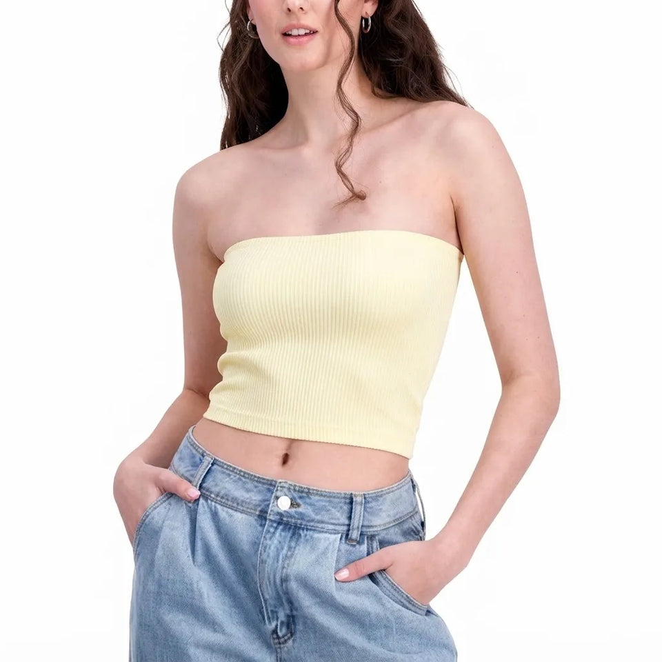 A woman wearing a pale yellow ribbed strapless tube top and light blue jeans, shown from the mouth down against a plain white background.