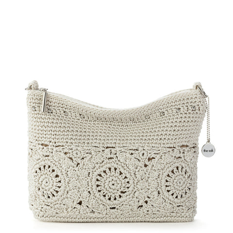 Crocheted handbag with floral patterns on a white background