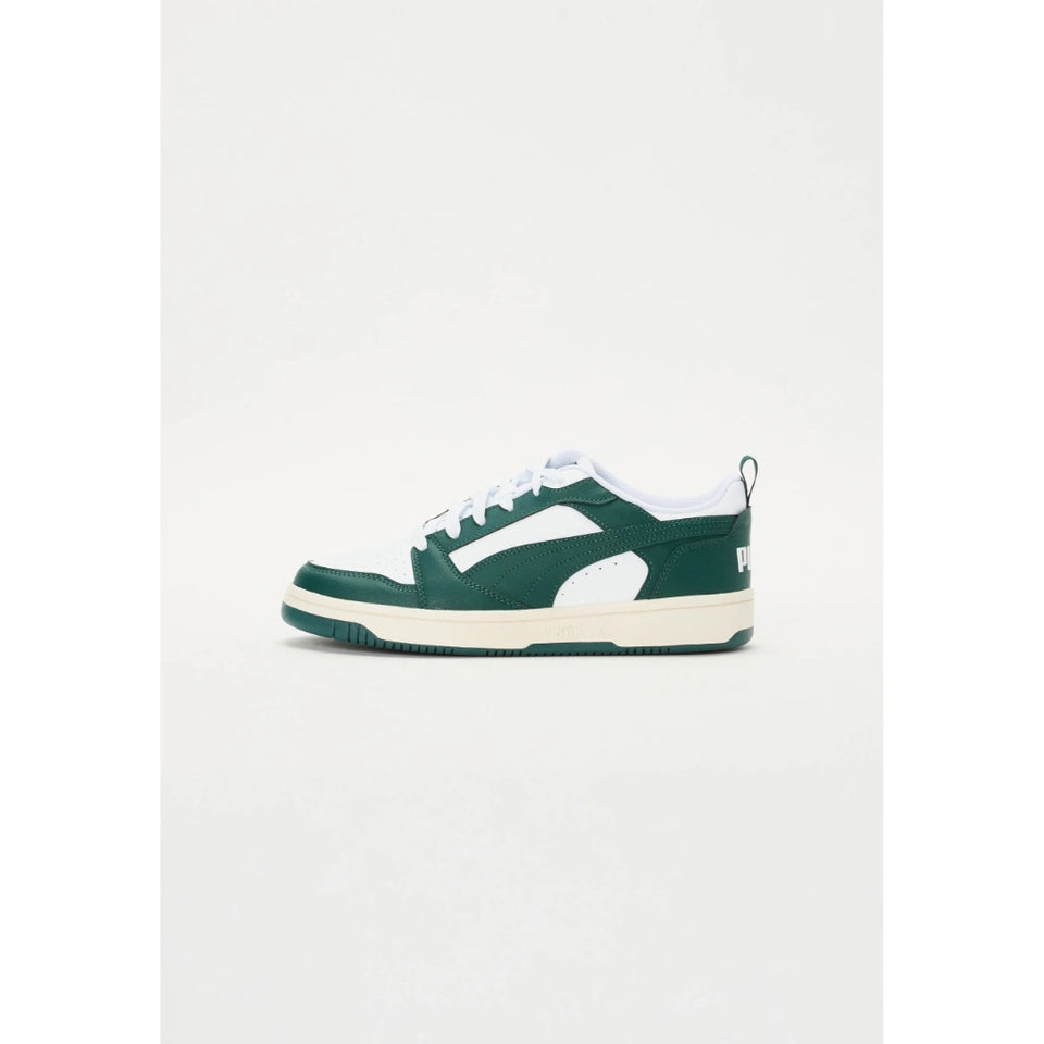 A single low-top sneaker in dark green and white, shown from the side against a plain light gray background.