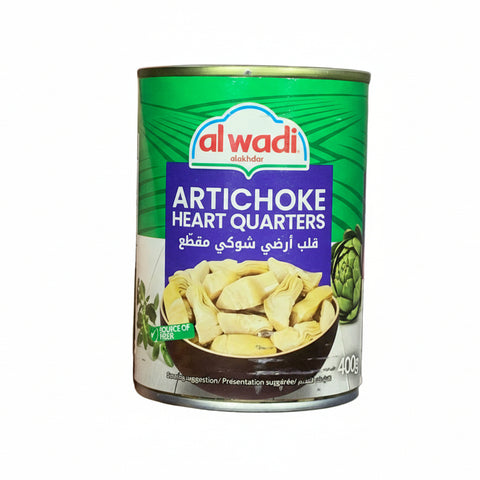 Hand holding a can of Al Wadi Artichoke Heart Quarters against a gray background