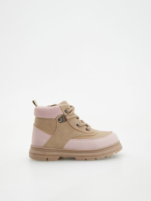 Beige and pink boots on a white background