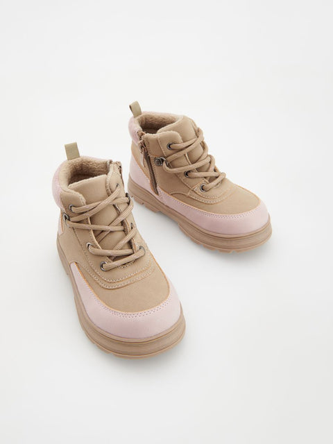 Pair of beige and pink high-top sneakers on a white background