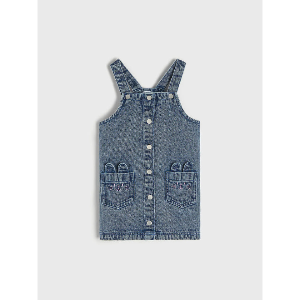 A blue denim baby/toddler overall dress with button-up front, shoulder straps, and decorative embroidered pockets on a light gray background.