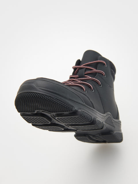 Black hiking boot with pink laces on a white background