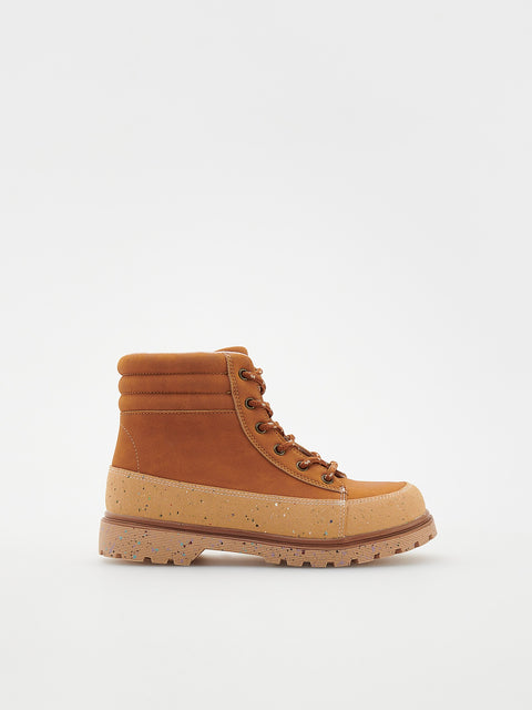 Brown boot with a textured sole on a white background