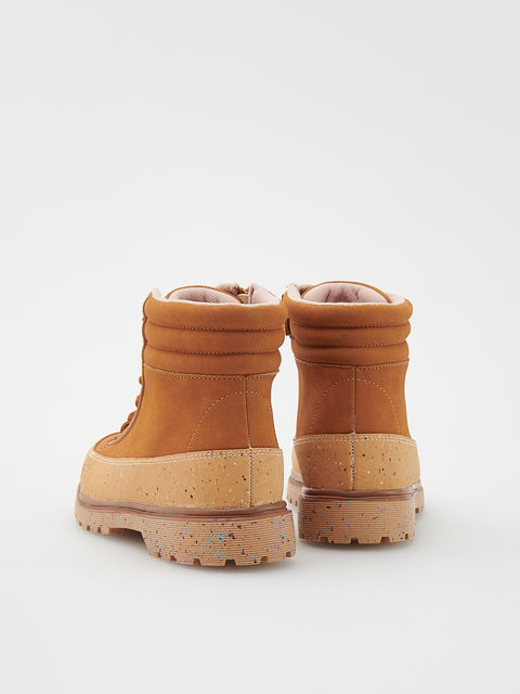 Pair of tan boots on a white background