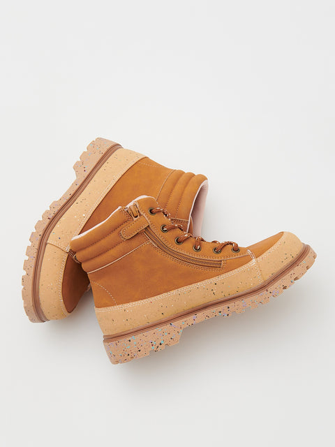 Pair of tan boots with a thick sole on a light background