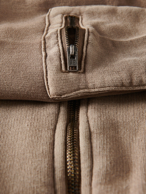 Close-up of a brown corduroy jacket with zipper details