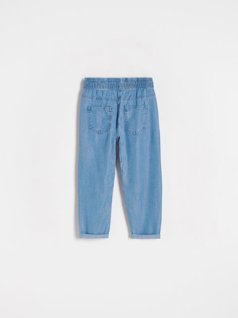 Light blue denim pants on a white background